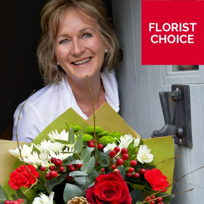 Christmas Florist Choice Hand-Tied - A festive hand-tied filled with the seasonal flowers, perfectly wrapped by the local florist and delivered in water.